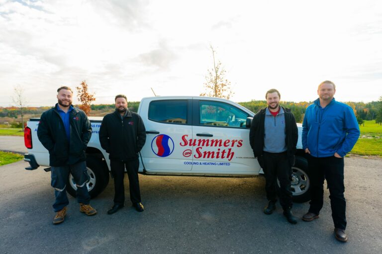 Summers and Smith technicians standing next to service truck
